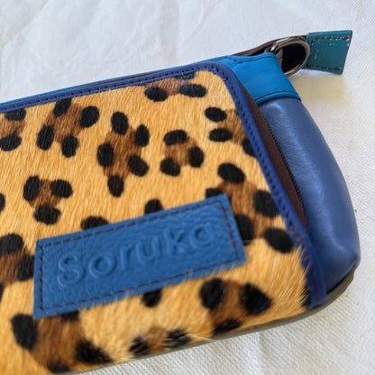 close-up of blue crossbody with leopard front pocket