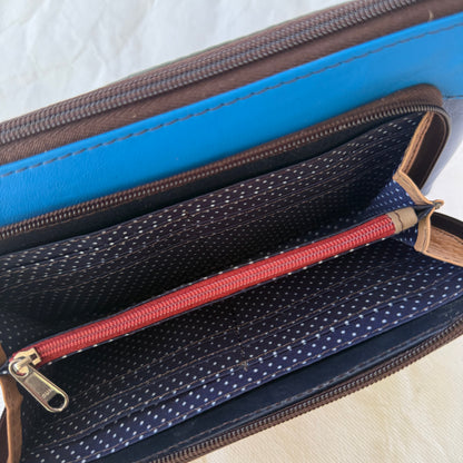 interior view of front pocket of small crossbody showing card slots and zippered pocket