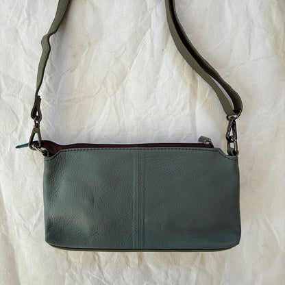 back view of small crossbody with grey backing