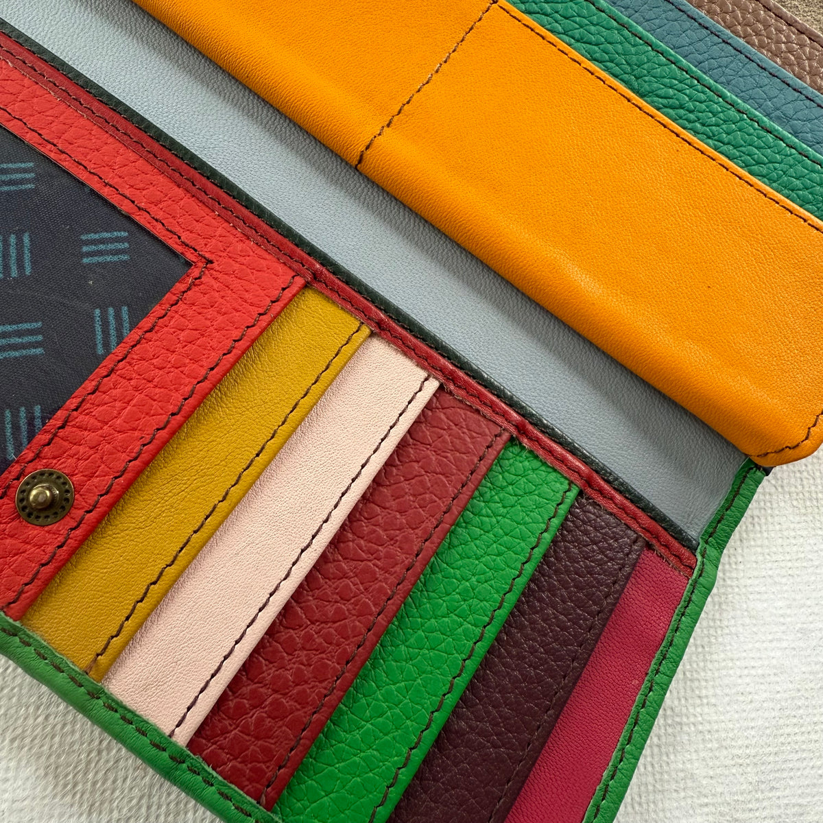 close-up of wallet showing colorful card slots and clear I D pocket