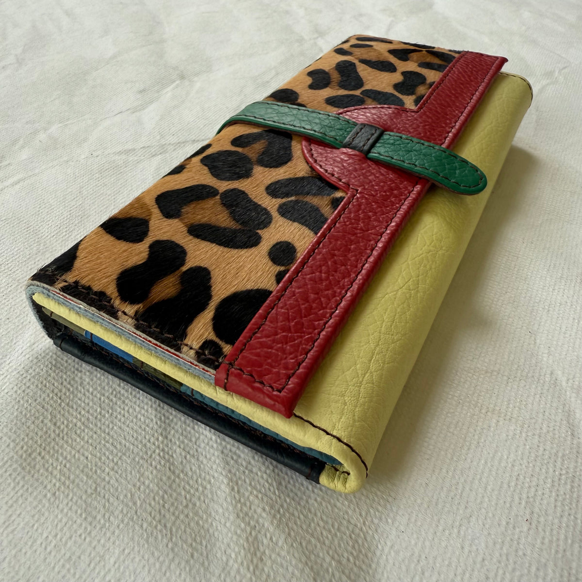 side view of wallet with leopard flap and yellow body