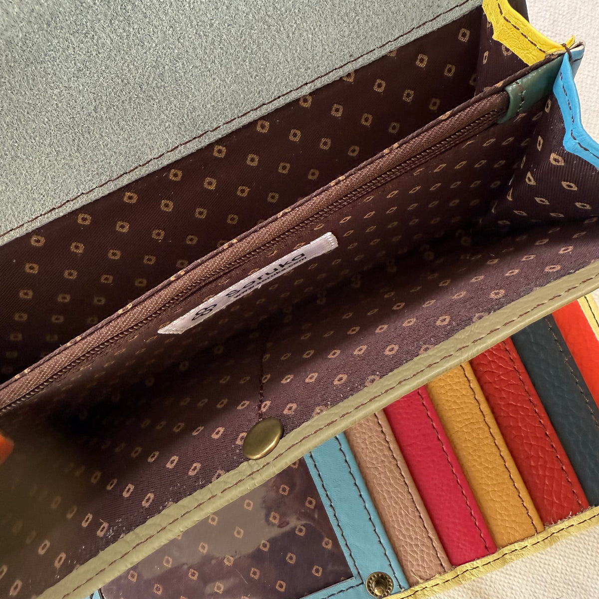 interior view of wallet with colorful card slots, cash slip wallets, and zippered coin pocket
