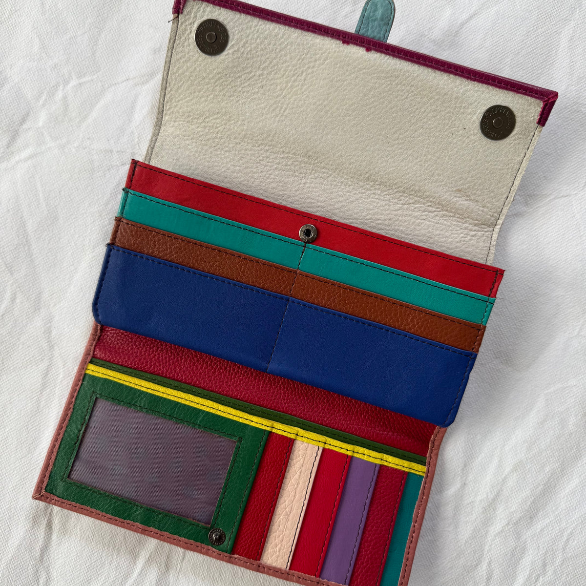 open wallet showing colorful card slots and clear I D pocket