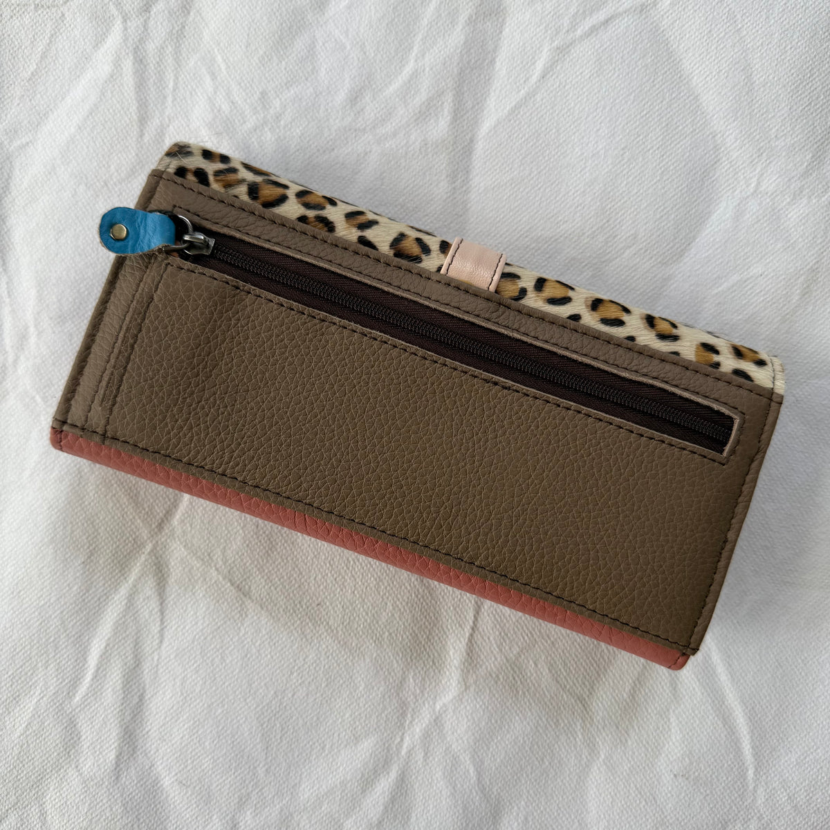 back view of wallet with taupe back and zippered pocket