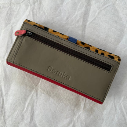 back view of wallet with taupe backing and zippered pocket