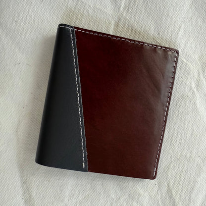 wallet with burgundy and grey leathers and white stitching
