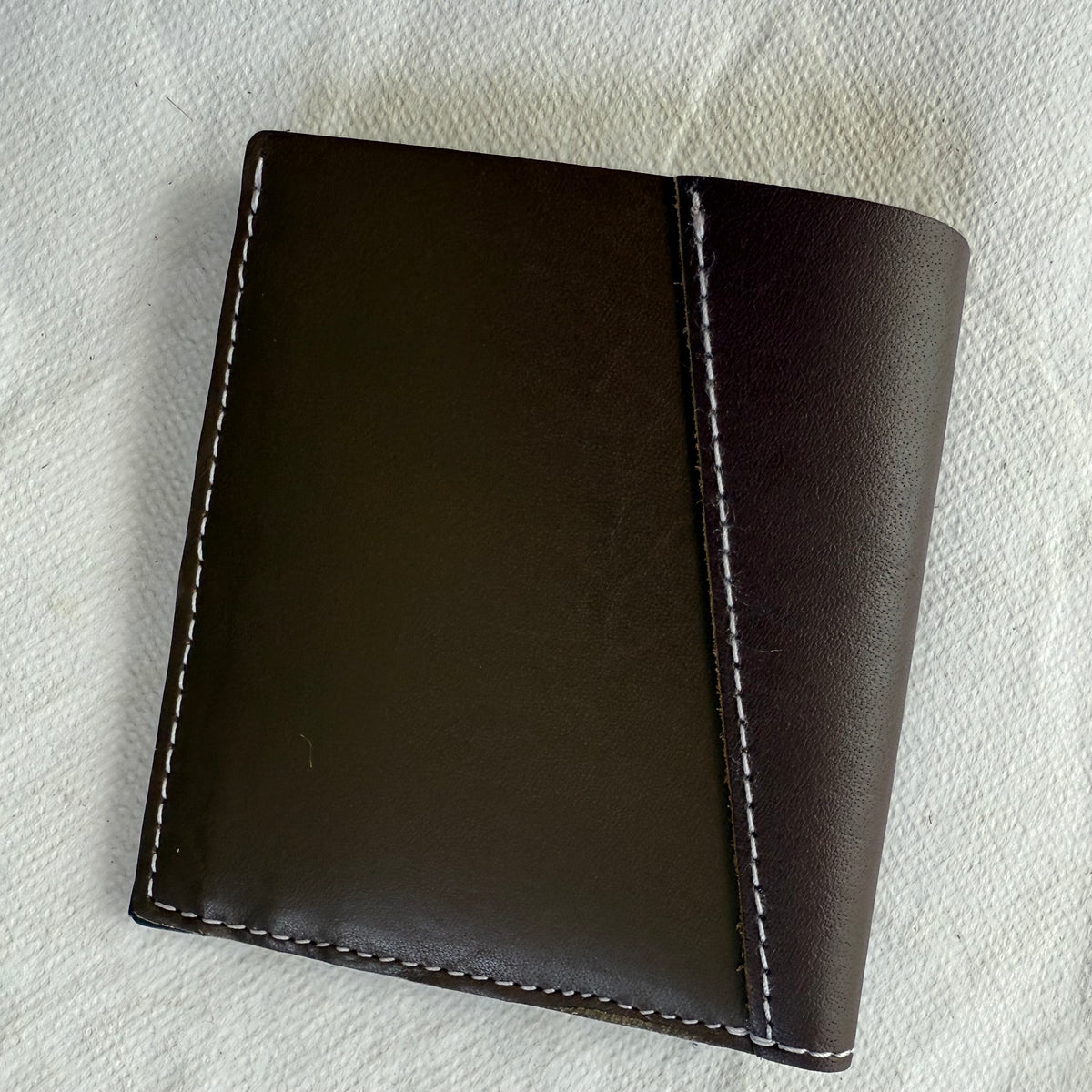 wallet with brown leathers and white stitching