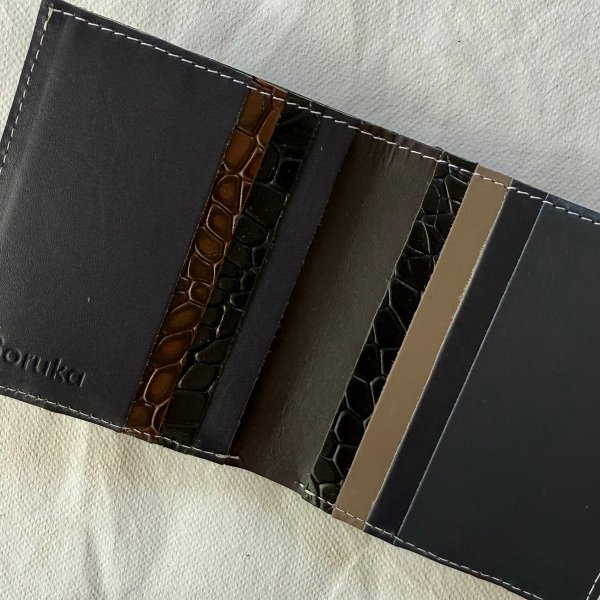 interior view of wallet with card slots in black and browns