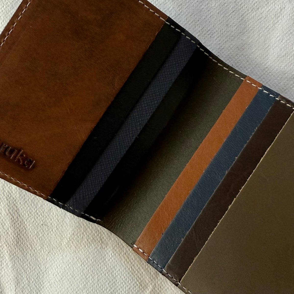interior view of wallet with card slots in browns and blues