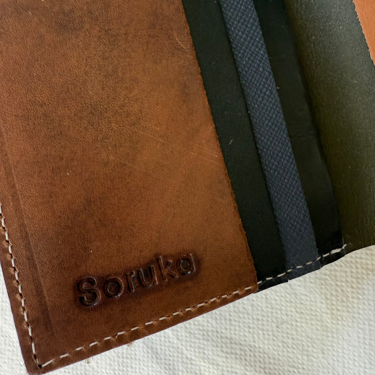 close-up of wallet with brown and blue card slots