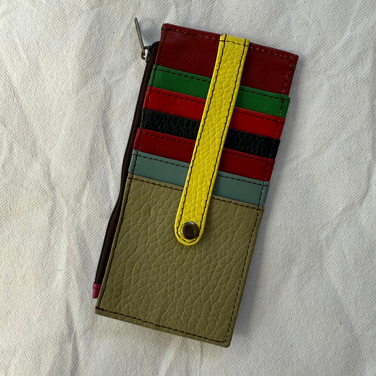 other side of flat wallet with colorful card slots and a zip pocket along the side