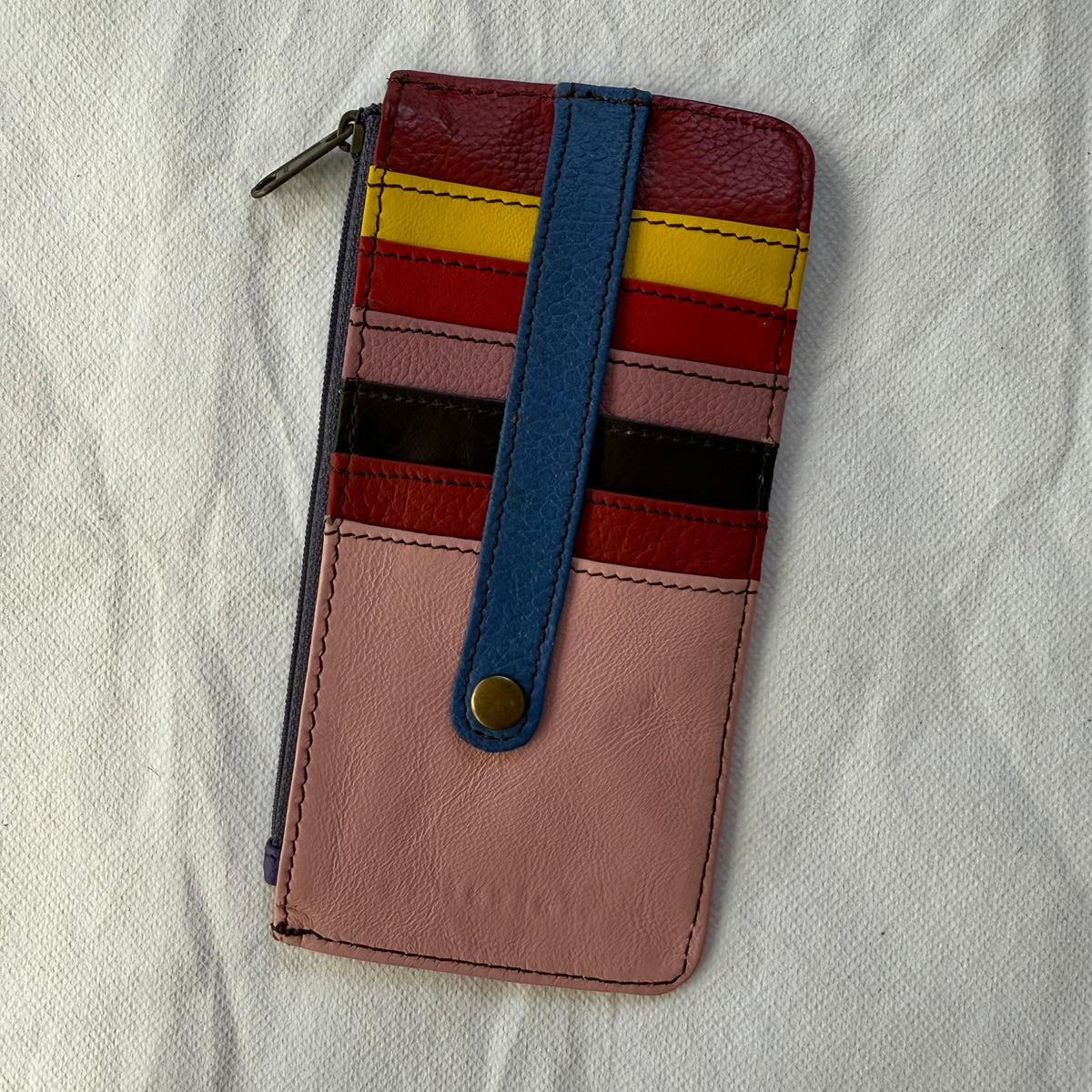 other side of flat wallet with colorful card slots and a zip pocket along the side