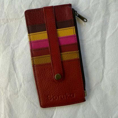 flat wallet with colorful card slots in red, pink, and yellow and a zip pocket along the side