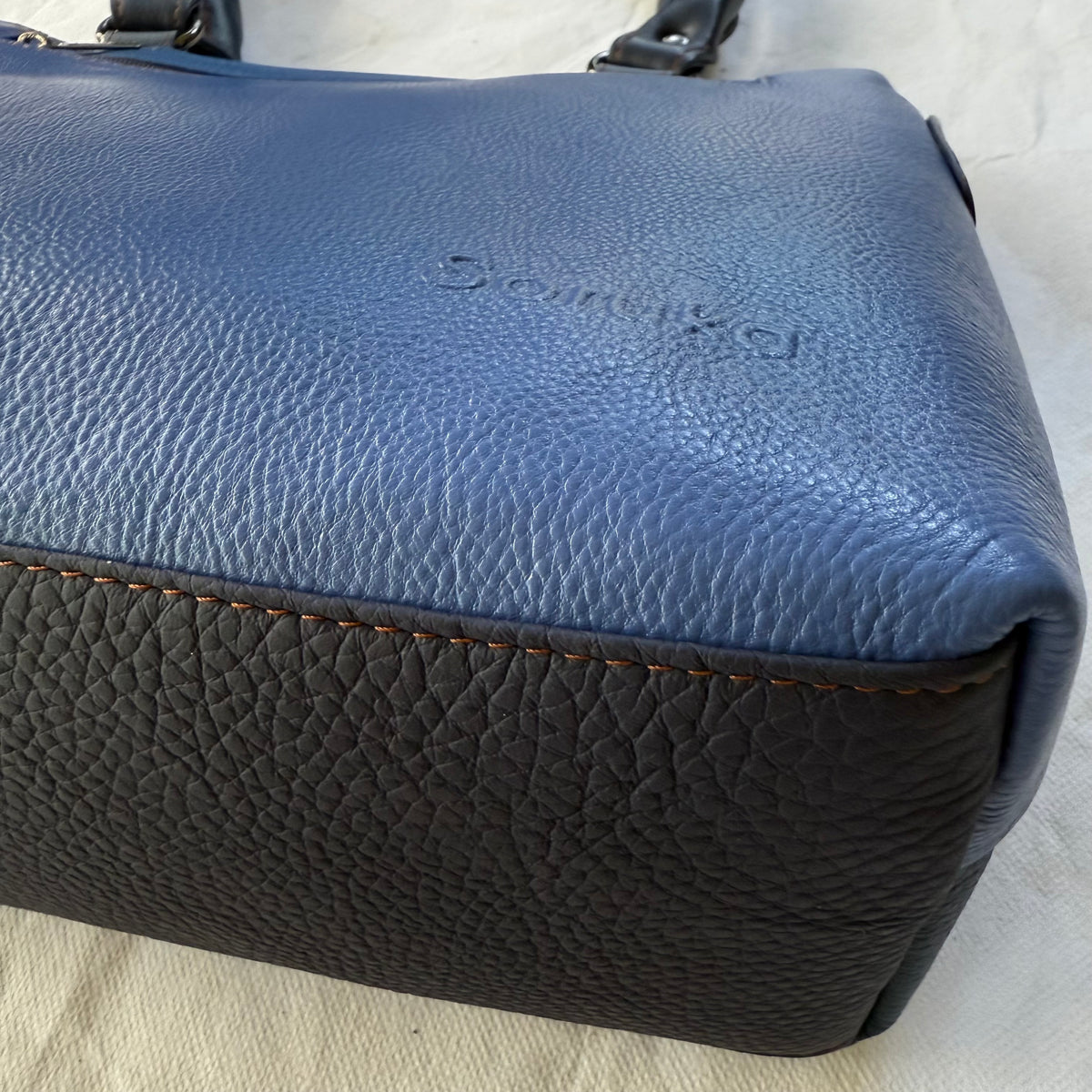 bottom view of blue handbag