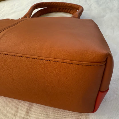 bottom view of orange leathe handbag