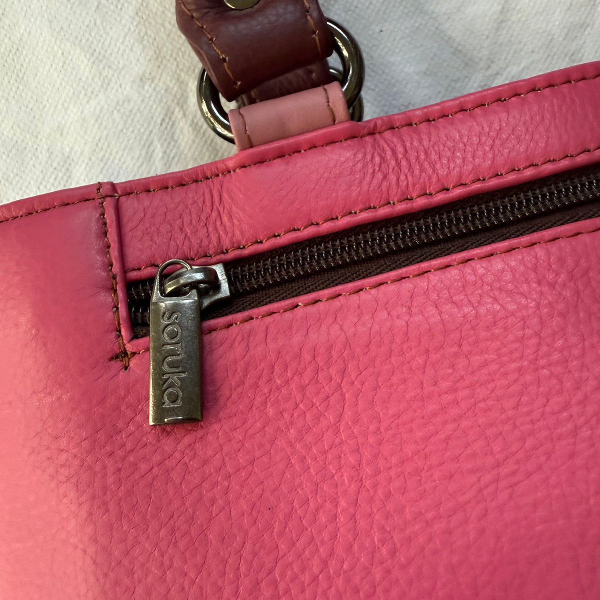 close-up of pink handbag with zipper pocket