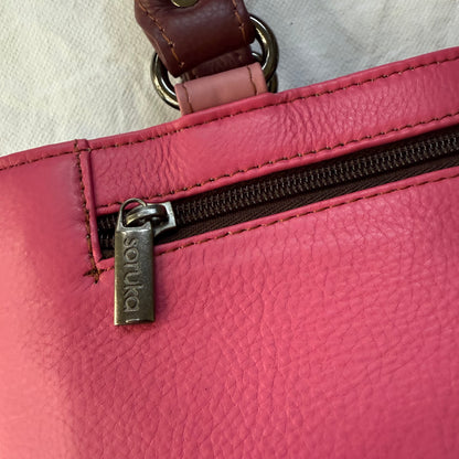 close-up of pink handbag with zipper pocket
