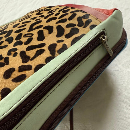 other side of backpack with mint green side panel with zipper