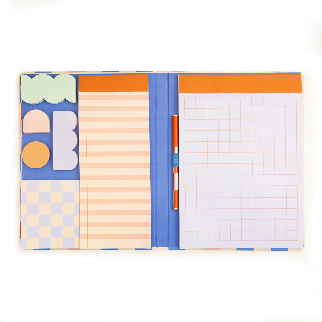 notebook open showing pen, sticky note, and other note pad