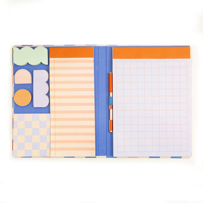 notebook open showing pen, sticky note, and other note pad