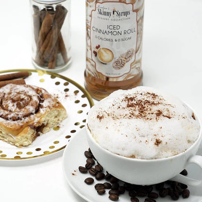 syrup surrounded by a plated cinnamon roll and coffee drink