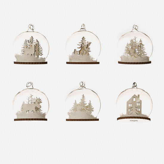 glass dome ornaments with wooden bases featuring miniature scenes inside, including trees, animals, and a house, shown against a white background.