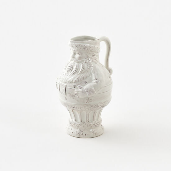 A white ceramic pitcher with a Santa Claus design featuring intricate details and a Christmas theme.