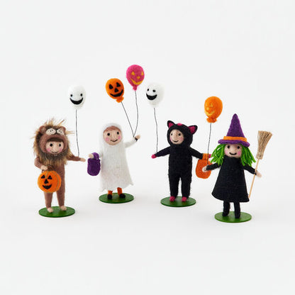 felt figures designed for Halloween, including a lion, a ghost, a black cat, and a witch, each holding a balloon.
