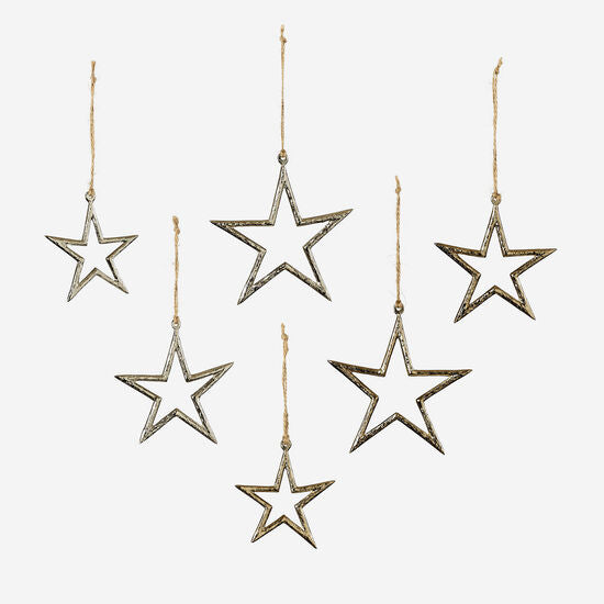 five metallic star ornaments of varying sizes, with a gold and silver finish, hanging on strings.