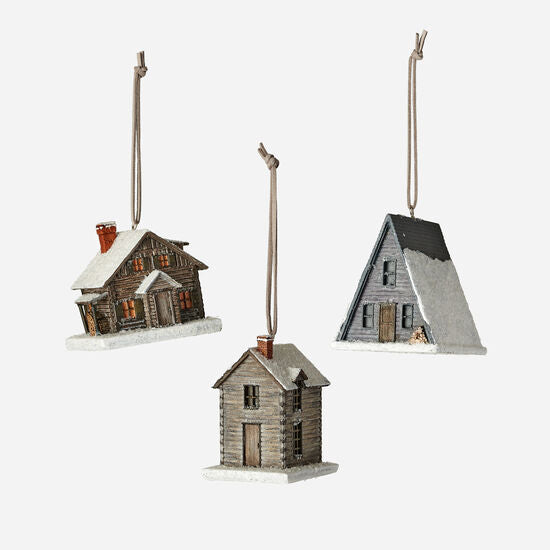 three cabin ornaments arranged on a white background