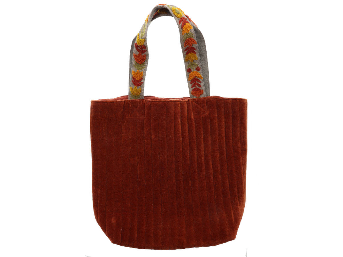 cinnamon colored velvet tote bag with floral handles on a white background.