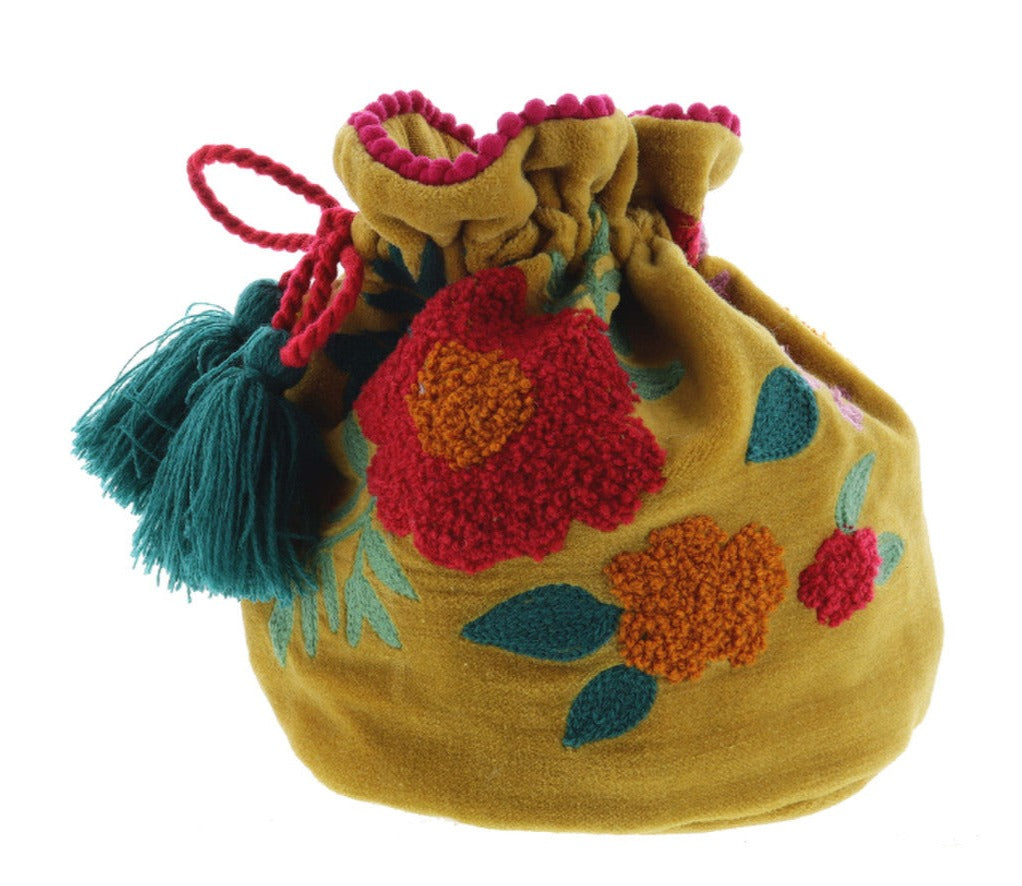 mustard colored velvet bag with floral embroidery on a white background.