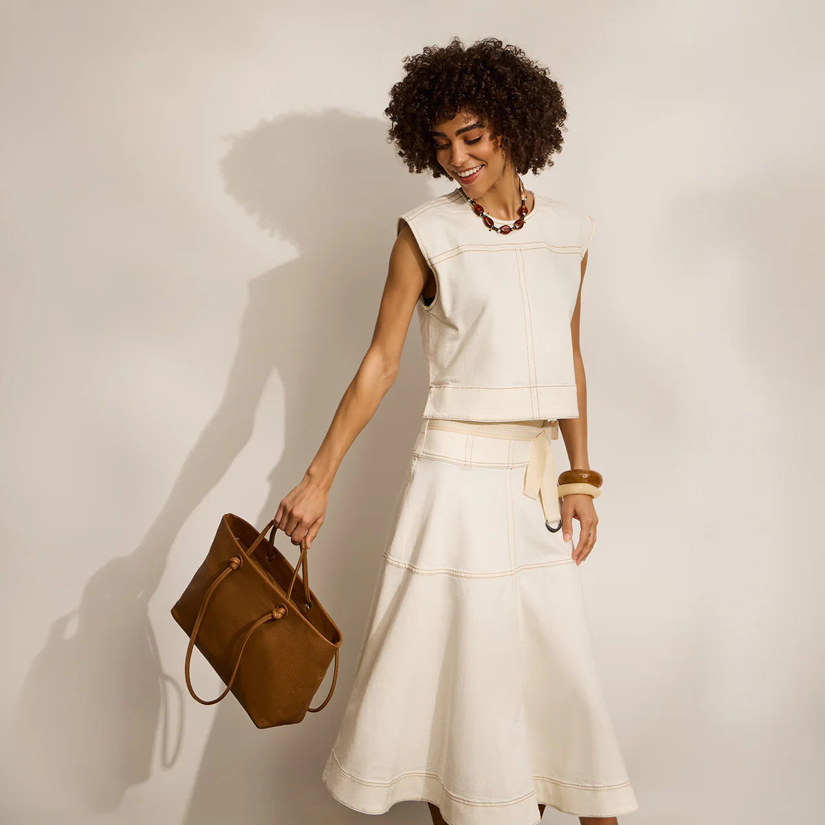 a person holding the softie tote in timber brown