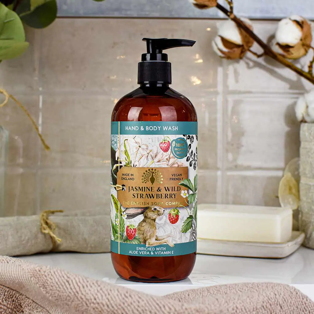 Hand and body wash bottle with Jasmine and Wild Strawberry label on a bathroom counter.