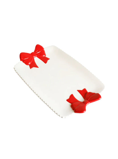 white platter with red bow on each end.