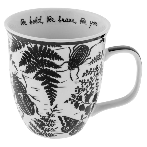 white mug with black images of leaves and beetles printed on it.