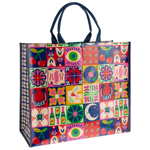 Colorful patterned tote bag with a patchwork design on a white background
