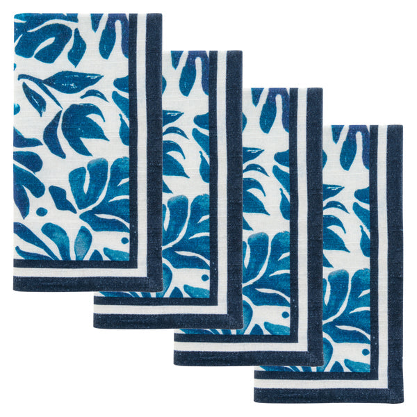 4 blue and white cloth napkins with navy striped boarders and abstract floral patterns.