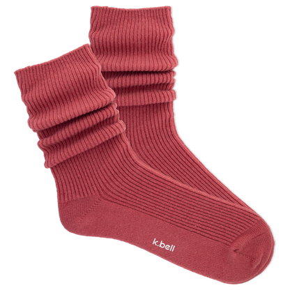 Pair of wine colored slouch socks on a white background