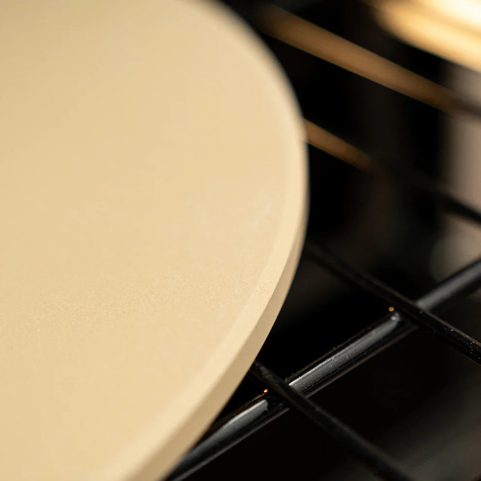 close-up of rounded edge of baking stone in a oven