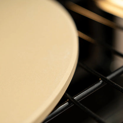 close-up of rounded edge of baking stone in a oven