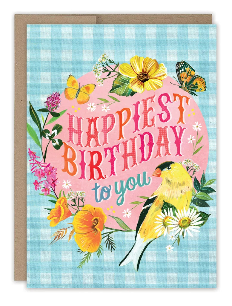 front of card featuring a gingham pattern, flowers and winged critters