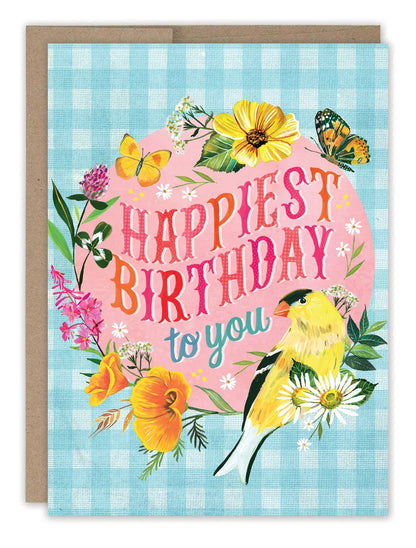 front of card featuring a gingham pattern, flowers and winged critters