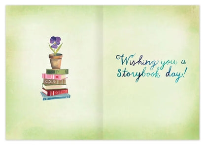 inside of card featuring a book stack and blue text
