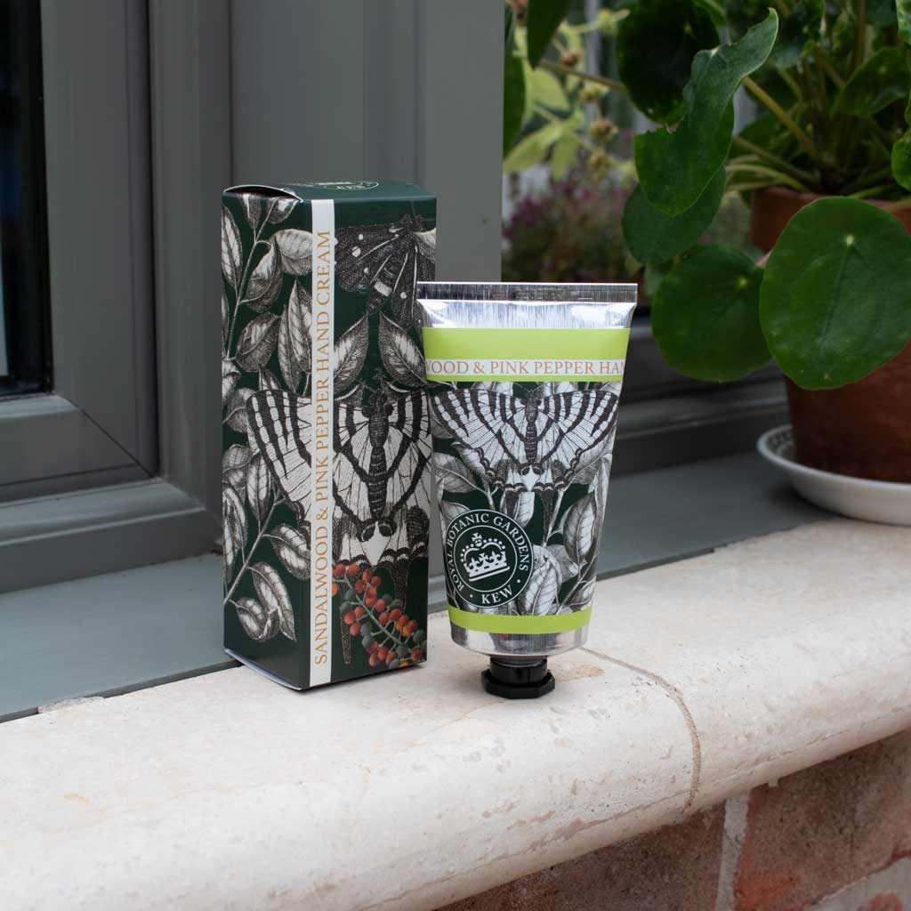 sandalwood and pink pepper lotion tube and box in a decorated setting