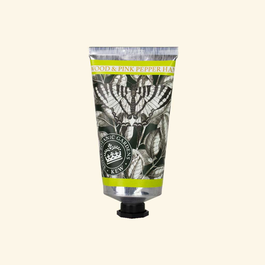sandalwood and pink pepper lotion tube on an ivory background
