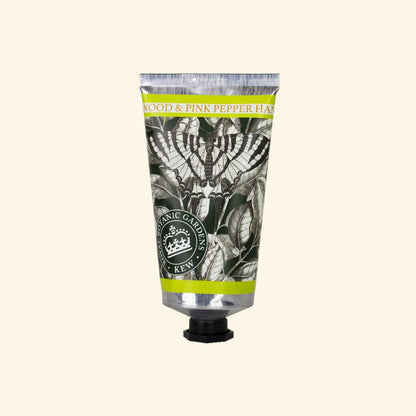 sandalwood and pink pepper lotion tube on an ivory background
