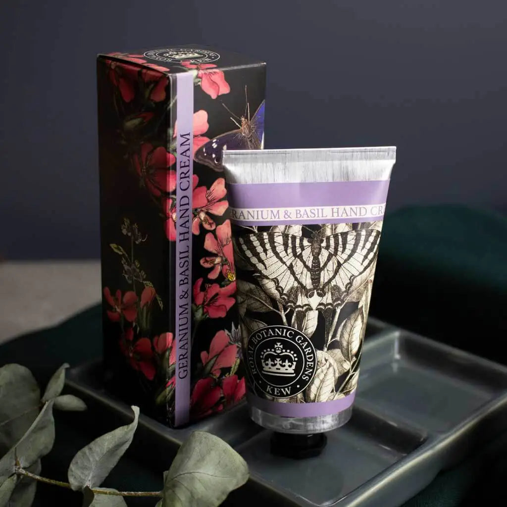 Hand cream and its packaging with floral design on a dark background