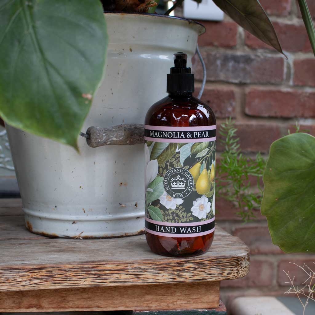pump bottle of magnolia and pear hand wash on a decorated background