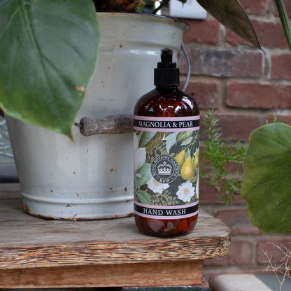 pump bottle of magnolia and pear hand wash on a decorated background